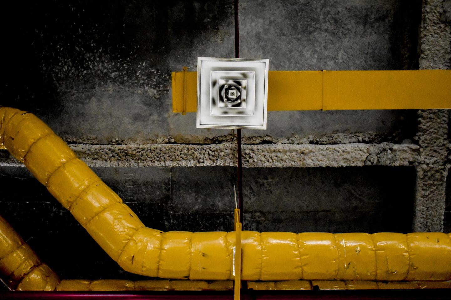 Ventilation grille and yellow pipes